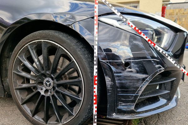 Nahaufnahme eines beschädigten Mercedes Vorderrads und Stoßfängers mit Markierungen für die Schadenanalyse.